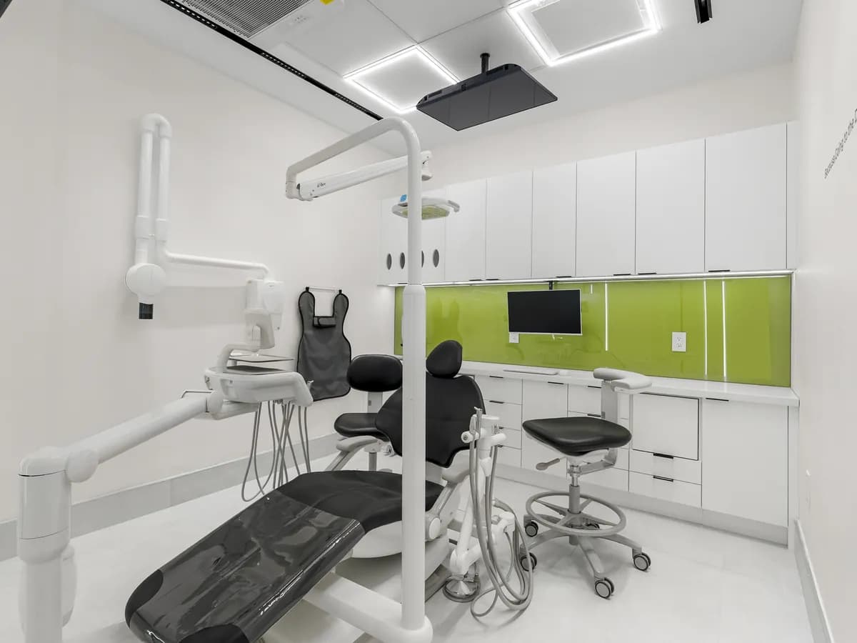 A second treatment room, chair ready under the ceiling light