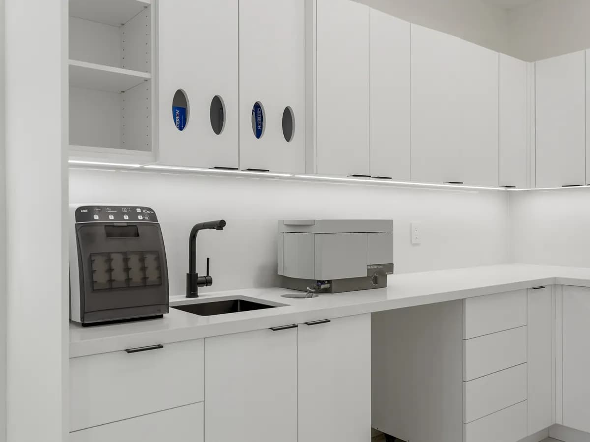 The sterilization bay with its instrument sterilizers and black sink