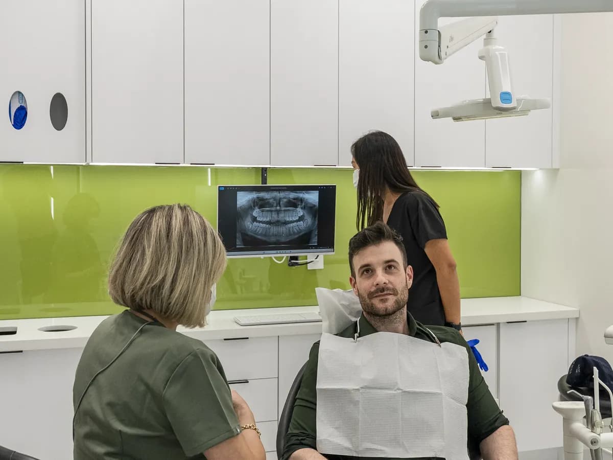 A patient in the chair describing a problem to Dr. Shay Rahmatian