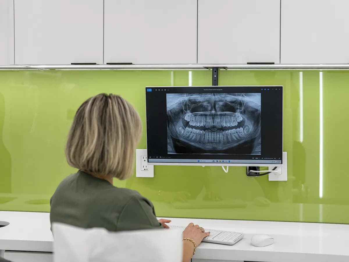 Dr. Rahmatian reviewing a panoramic X-ray on the chairside screen
