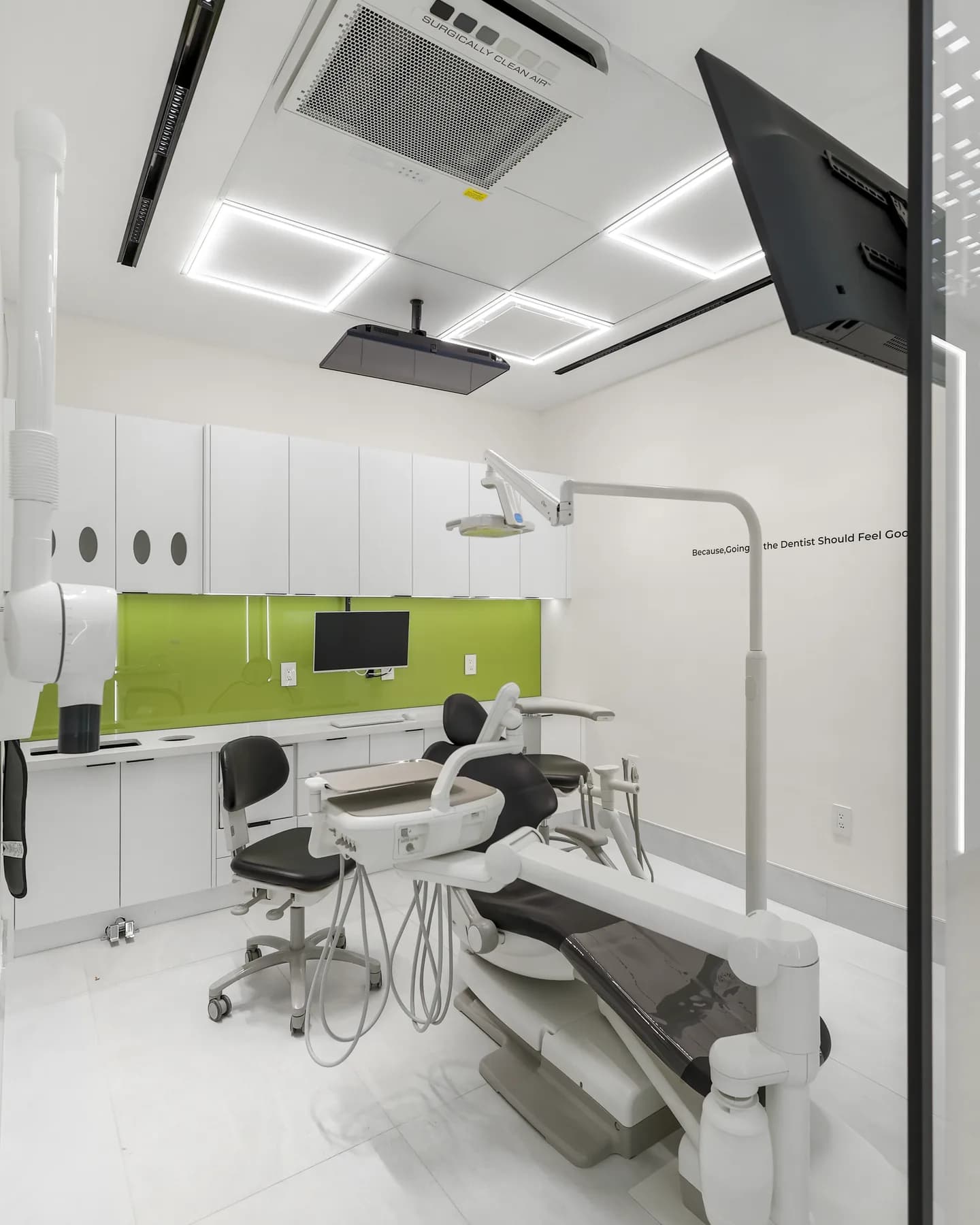 A treatment room at Allo Dental Clinic standing ready, X-ray apron on the wall